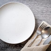 An empty plate with a knife and fork on the side